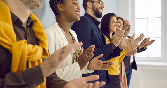 employees clapping and congratulating each other